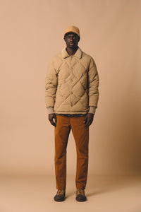 A man wearing the KESTIN Dunbar Jacket, which is a warm, insulated winter layer.