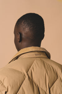 This model is wearing the KESTIN Dunbar Jacket, which is a padded winter jacket with synthetic down.