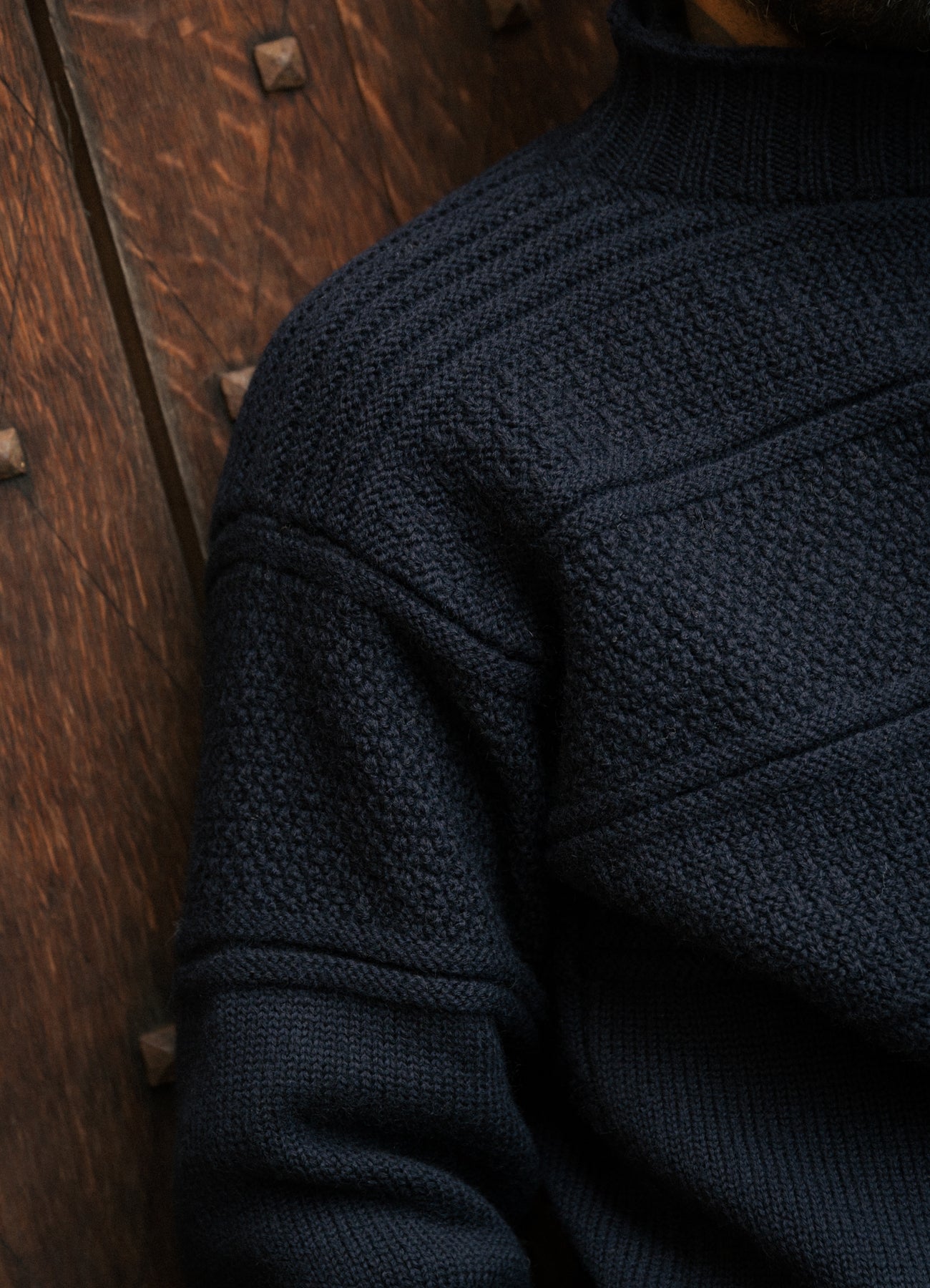 The shoulder panel of the KESTIN Fife Gansey Sweater in Navy Blue.