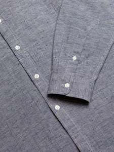A close-up of the buttoned cuff of the KESTIN Dirleton Shirt in Japanese blue slub.