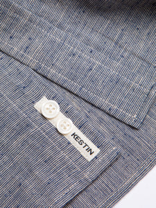 A KESTIN logo patch sewn to the hem of the KESTIN Dirleton Shirt in blue slub.
