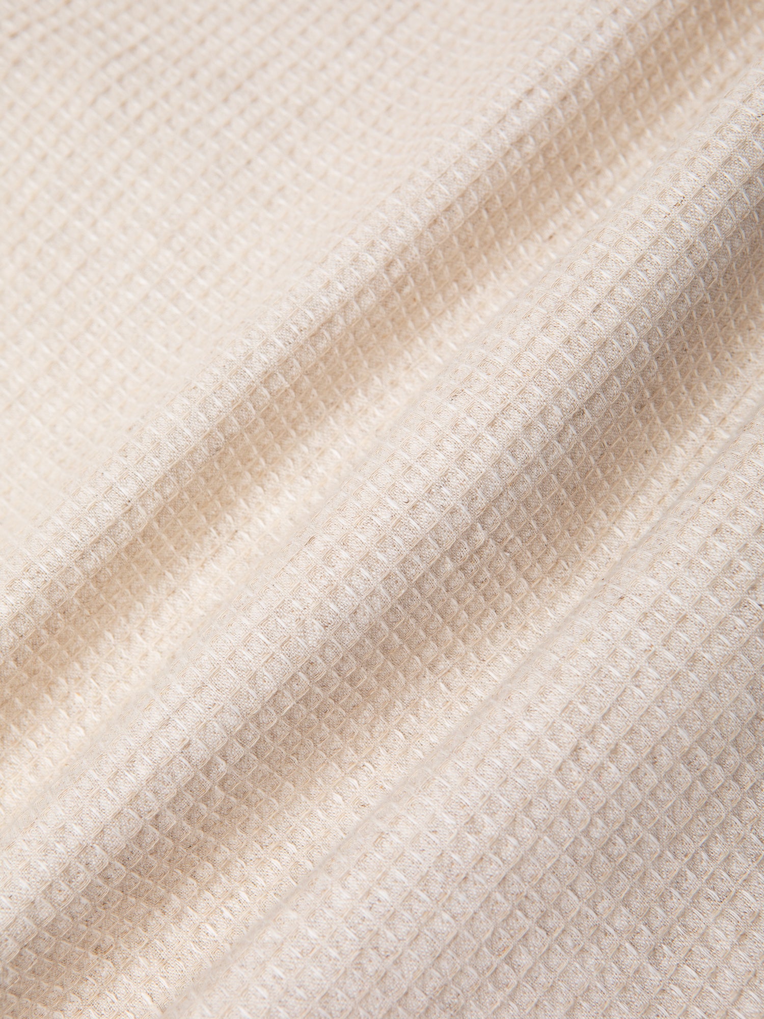 An ecru linen and cotton waffle fabric, used to make the KESTIN Ormiston Jacket.