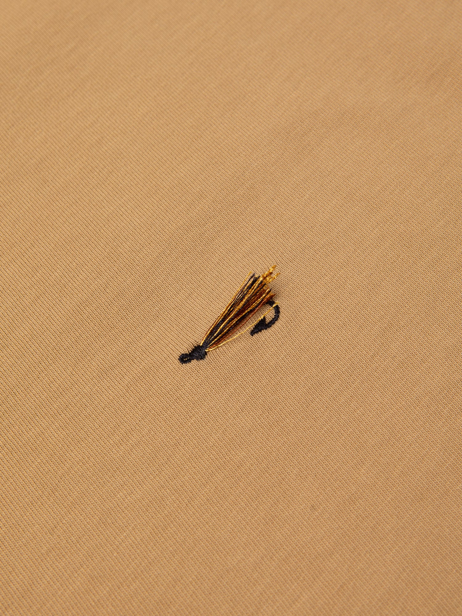 An embroidered fishing fly to the chest of the KESTIN Cargill Tee.