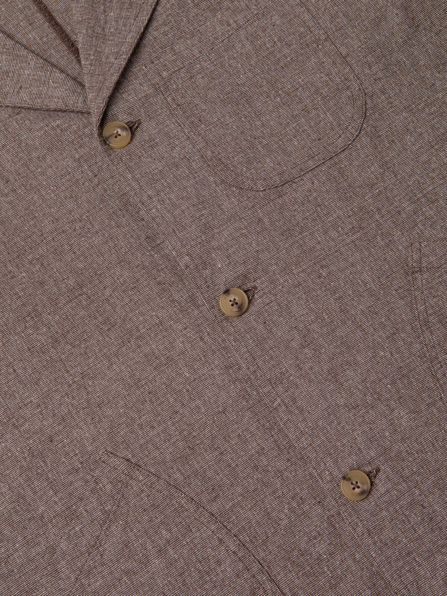 The front, including buttons and patch pockets, of a men's workwear-inspired suit jacket.