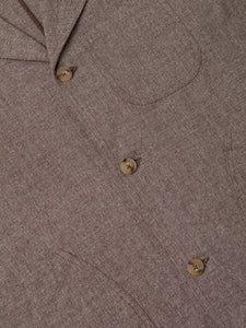 The front, including buttons and patch pockets, of a men's workwear-inspired suit jacket.