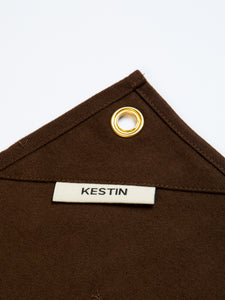 A woven flag label to a cotton twill workwear-inspired apron by KESTIN.