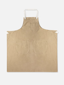 A tan coloured cotton twill apron by menswear brand KESTIN.