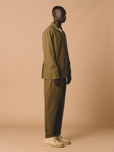 A model showing the side profile of KESTIN's Clyde Pants and Port Jacket.