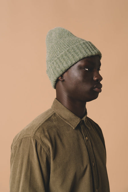 A model wearing the KESTIN Balloch Beanie, made from a soft brushed wool.