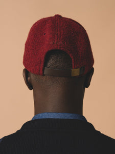 A virgin wool fleece six panel cap by KESTIN with a leather strap to the back.