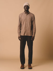 A model wearing the Raeburn Shirt and Inverness Trousers by menswear designer KESTIN.
