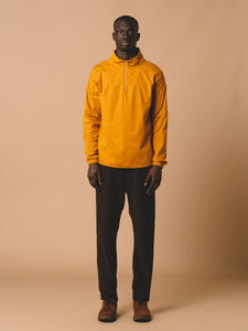 A model wearing the KESTIN Crieff Windbreaker, made from stretch cotton in a bright yellow.