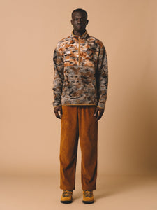 An orange and grey pullover fleece from menswear brand KESTIN, worn on a model.