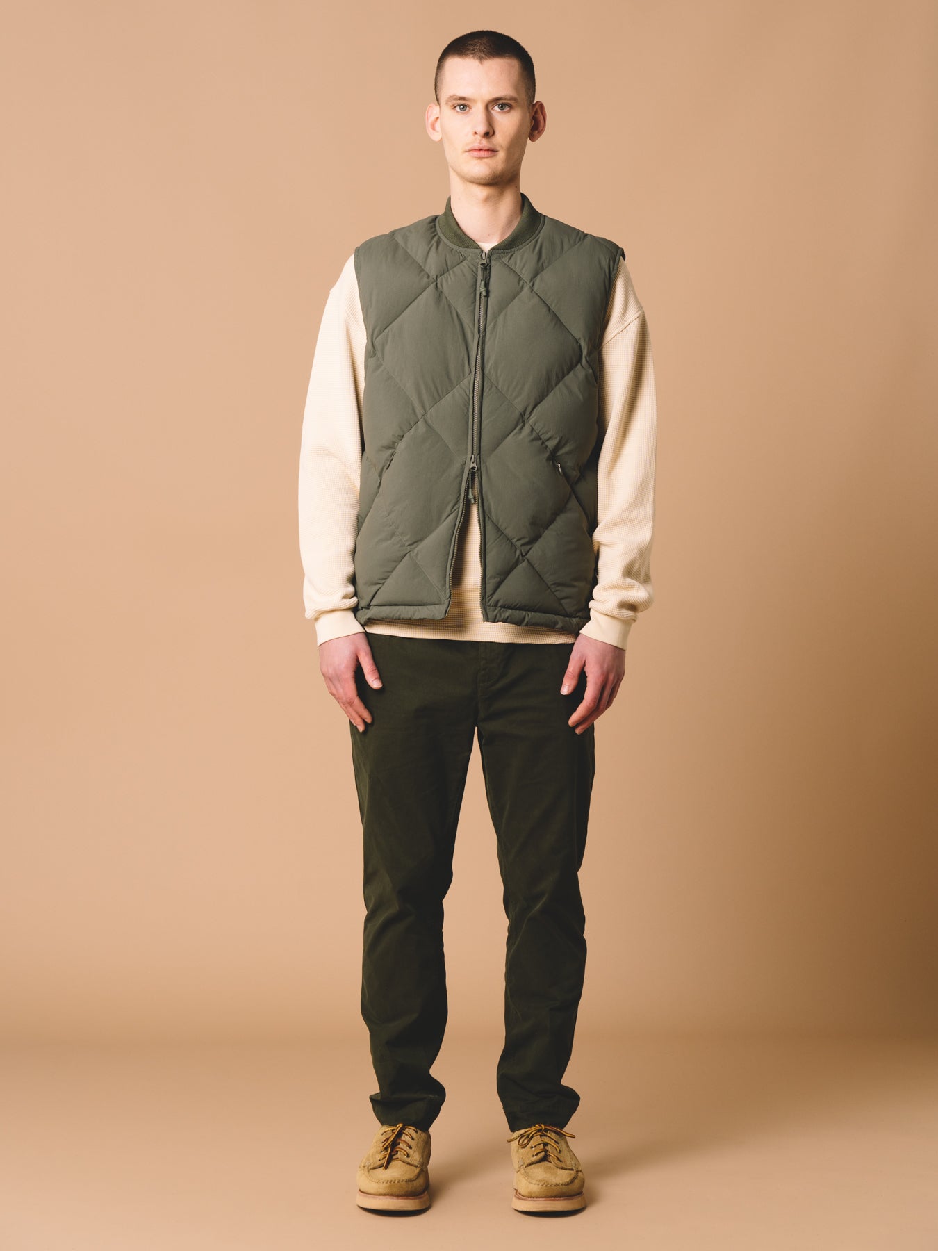 A model wearing the KESTIN Linton Vest, which is made from a recycled synthetic insulation.