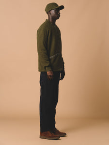 The side profile of the KESTIN Dreghorn Fleece in a dark green colour.