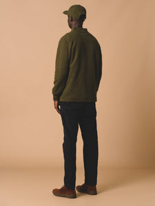 The back profile of a dark green fleece, made by designer brand KESTIN.