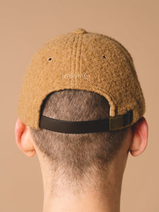 A leather strap and embroidered logo to the back of the Comets Cap in camel brown.