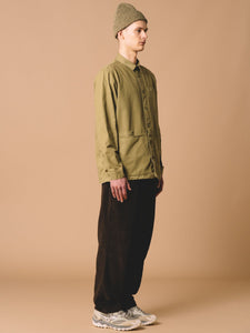 An overshirt from Scottish menswear designer KESTIN, worn with a beanie and corduroy trousers.