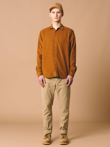 The Dirleton Shirt by Scottish menswear designer KESTIN, worn in Tobacco Brown Corduroy with a Comets Fleece Cap and the slim fit Inverness Trousers.
