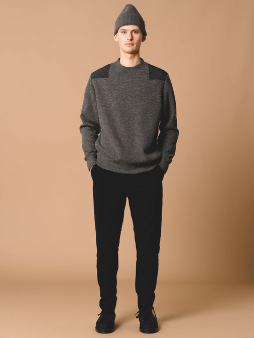 A model wearing a grey knitted sweatshirt, designed by premium menswear brand KESTIN.