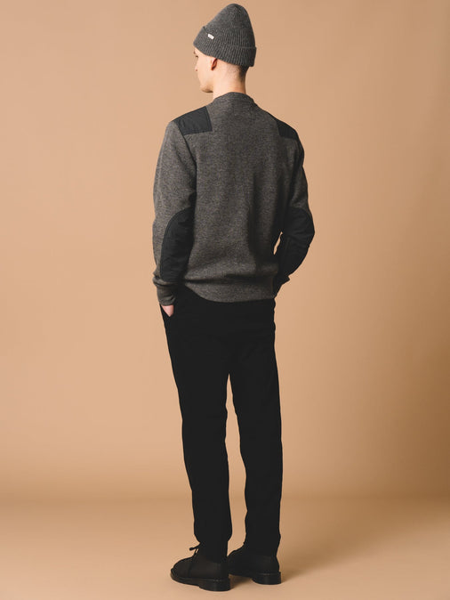A man wearing premium knitwear, designed by KESTIN and made from grey wool.