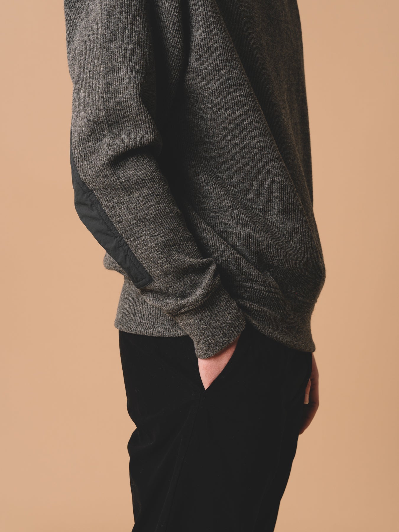 A knitted sweater made from a comfortable technical recycled Japanese wool in grey.