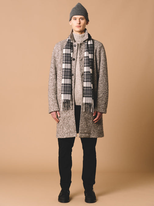 A men's autumn/winter outfit inspiration, with grey knitwear, fleece and black corduroy.