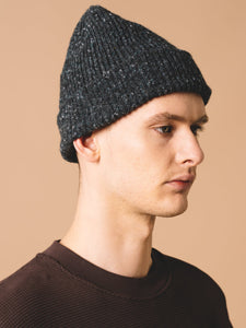 A model wearing a knitted beanie, made in Scotland by premium menswear brand KESTIN.