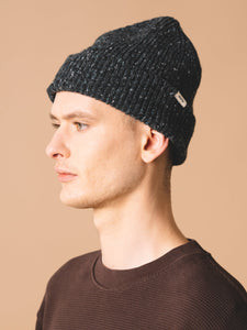 A model wearing a made in Scotland beanie, from menswear brand KESTIN.