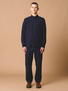 This model is wearing the KESTIN Raeburn Button Down Shirt, which is a workwear version of a traditional Oxford Shirt.