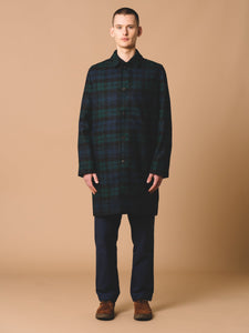 This model is wearing a British Wool Overcoat from the Autumn/Winter 2023 collection by Scottish designer KESTIN, in a traditional Black Watch Tartan check.