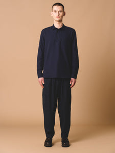 This model is wearing the KESTIN Granton Shirt, which is a traditional workwear-style pop-over Polo Shirt in Navy.