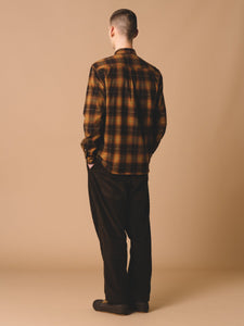 This model is wearing the KESTIN Dirleton Shirt, made from a premium Japanese flannel, and the Wick Trousers, made in an Autumnal Dark Brown corduroy.