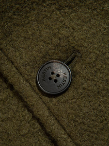 A premium Italian Wool material in Dark Green, featuring a branded logo button from British men's brand KESTIN.
