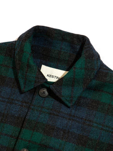 The close-up of a collar from a warm winter overcoat, designed by British menswear brand KESTIN with a traditional Scottish Black Watch Tartan check pattern.