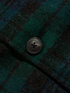 A branded button from British men's designer KESTIN, sewn onto the Black Watch Tartan Edinburgh Overcoat.