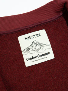 The neck label from a dark red fleece, designed by menswear brand KESTIN.