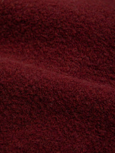 A premium Italian wool fleece material, in burgundy dark red.