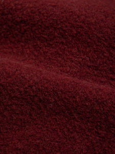 A premium Italian wool fleece material, in burgundy dark red.