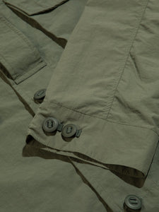 A buttoned, adjustable cuff from a lightweight Italian nylon shacket.