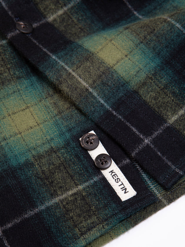 A close up of the logo patch from the KESTIN Men's Dirleton Shirt, which is a classic Flannel Shirt with a Check Pattern.