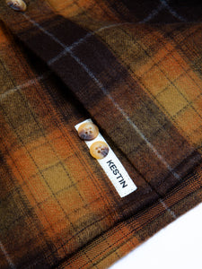 A woven logo patch, sewn to the placket of the KESTIN Dirleton Shirt, which is a traditional Flannel Shirt made from a premium Japanese cotton.