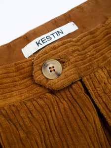 The front button on KESTIN's Wick Trousers, made from a brown corduroy.