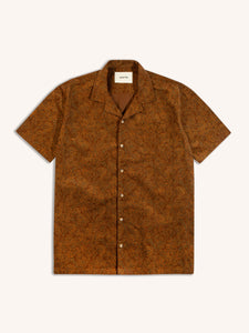 A short sleeve shirt made from a brown paisley corduroy, on a white background.