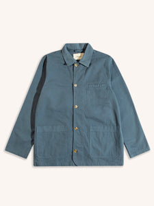 A blue chore coat-style jacket from menswear brand KESTIN, on a white background.