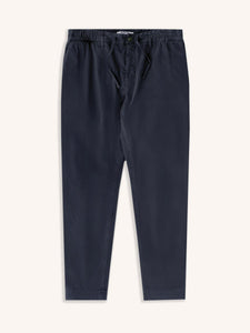 A pair of men's slim tapered pants in navy blue, on a white background.
