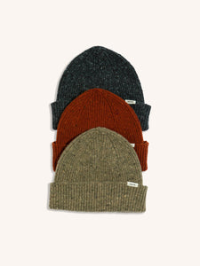 Three knitted beanies from designer menswear brand KESTIN, in red, beige and charcoal.