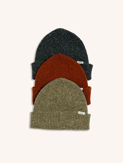 Three beanies in grey, red and beige, made in Scotland from premium wool.