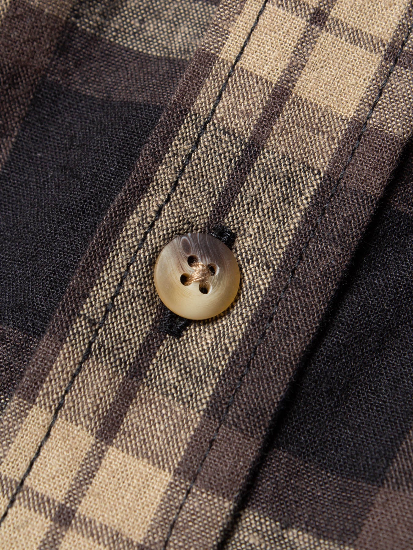 A button from the KESTIN Raeburn Shirt.