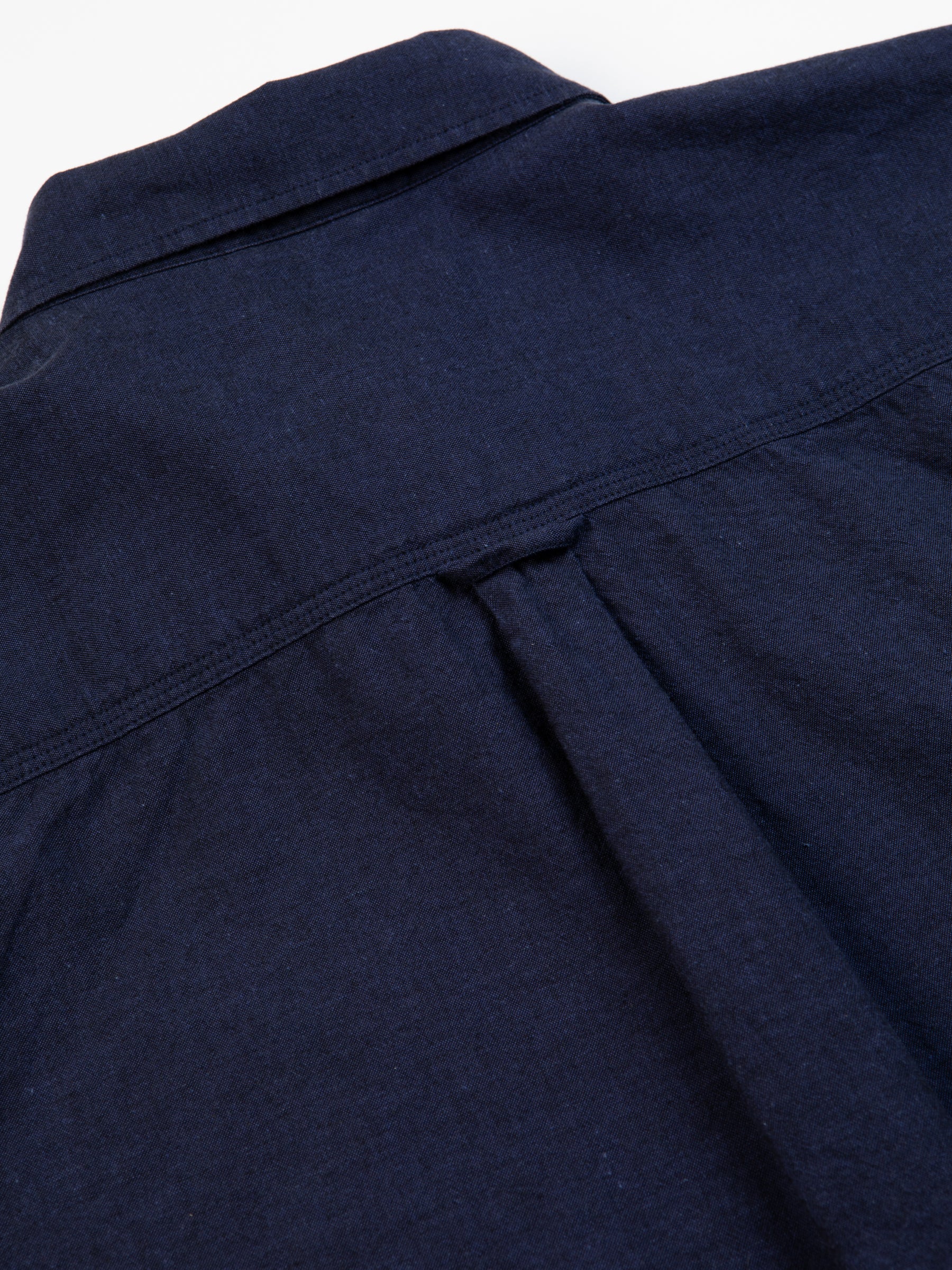 The pleated back of a men's Oxford Shirt by designer menswear brand KESTIN.